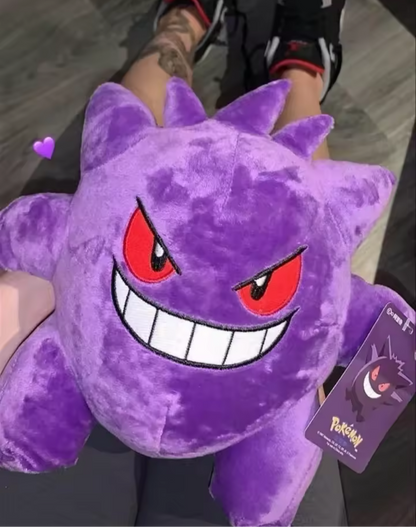 Gengar plush toy, purple and black, with a mischievous grin.
A soft, cuddly Gengar plush toy. He's got big, purple eyes, a wide grin, and a mischievous look. Perfect for any Pokémon fan!

This Gengar plush is ready to haunt your heart (and your shelf!). He's soft, squishy, and just begging for a cuddle.